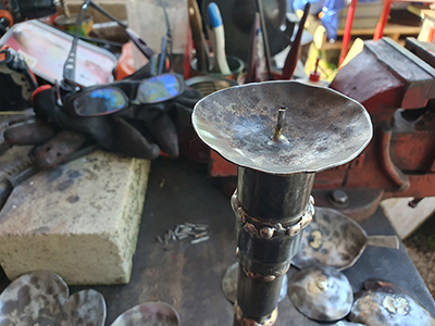 An image of unique candle stick holders being made by McKinley Rd Creatives  using recycled steel
