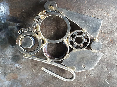 An image of a recycled metal trivet welded by Graham Hughes of McKinley Rd Creatives